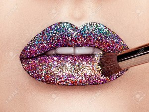 Close up view of Beautiful Woman Lips with Colorful Lipstick. Open Mouth with white Teeth. Cosmetology, drugstore or Fashion Makeup Concept. Beauty studio shot. Passionate Kiss